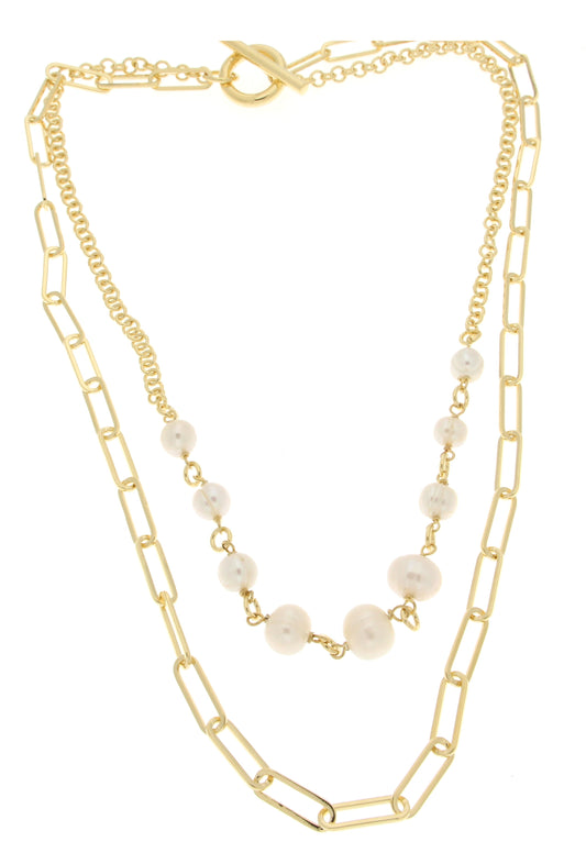 Gold layered necklace featuring elongated links and a strand of glossy white pearls, secured with a toggle clasp.