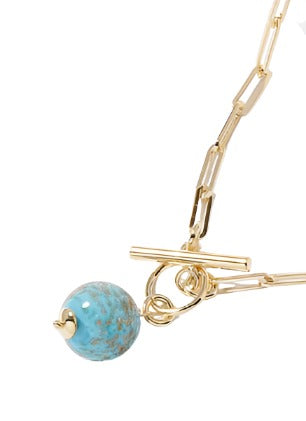 Gold chain necklace with elongated links and a large round turquoise bead, featuring a toggle clasp.