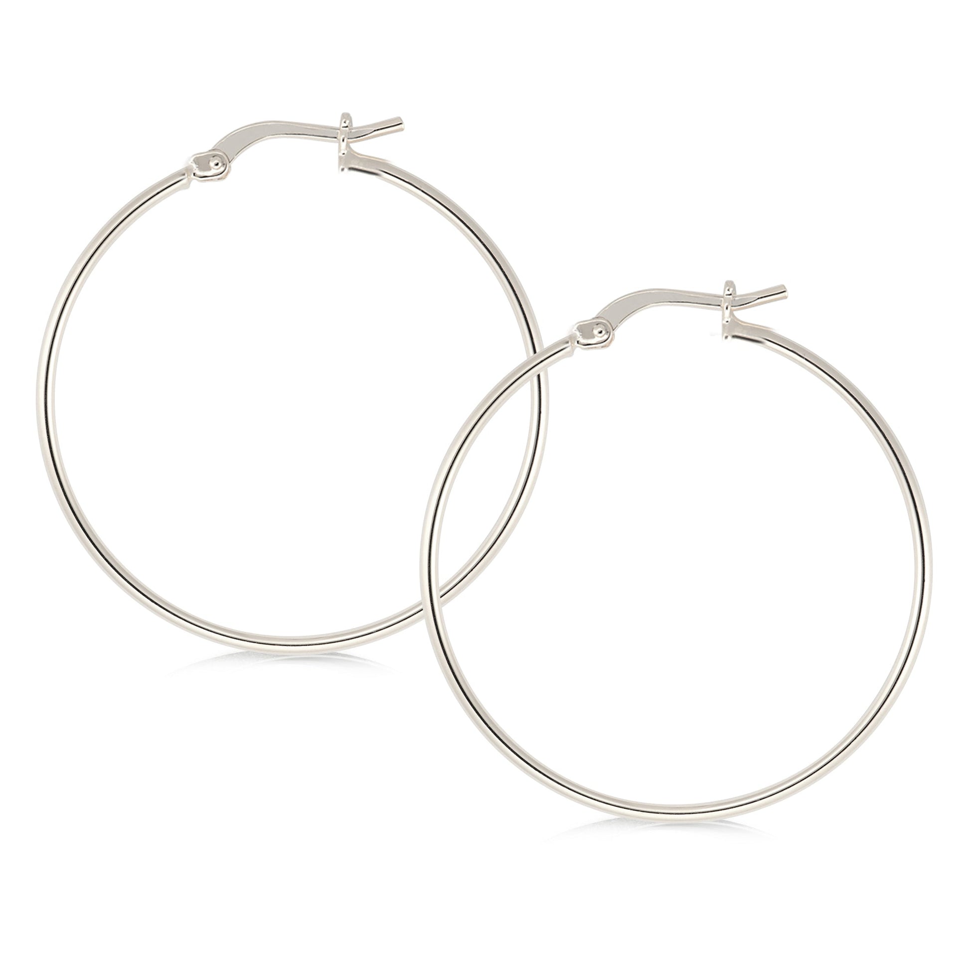 Elegant silver-tone hoop earrings featuring a minimalist design. The hoops are thin and polished, offering a refined and stylish look. They secure with a classic latch closure, making them suitable for both casual and formal occasions.