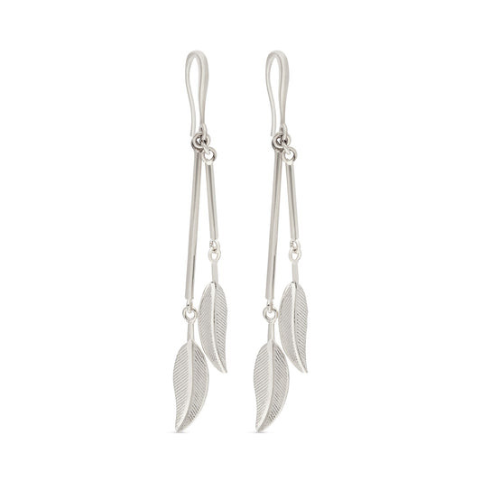 A pair of stylish silver-tone drop earrings featuring elongated, thin bars that lead down to delicate leaf-shaped pendants. Each pendant is intricately detailed with textured veins, giving it a natural and elegant appearance. The earrings hang from slim hooks, providing a lightweight feel and allowing for graceful movement.