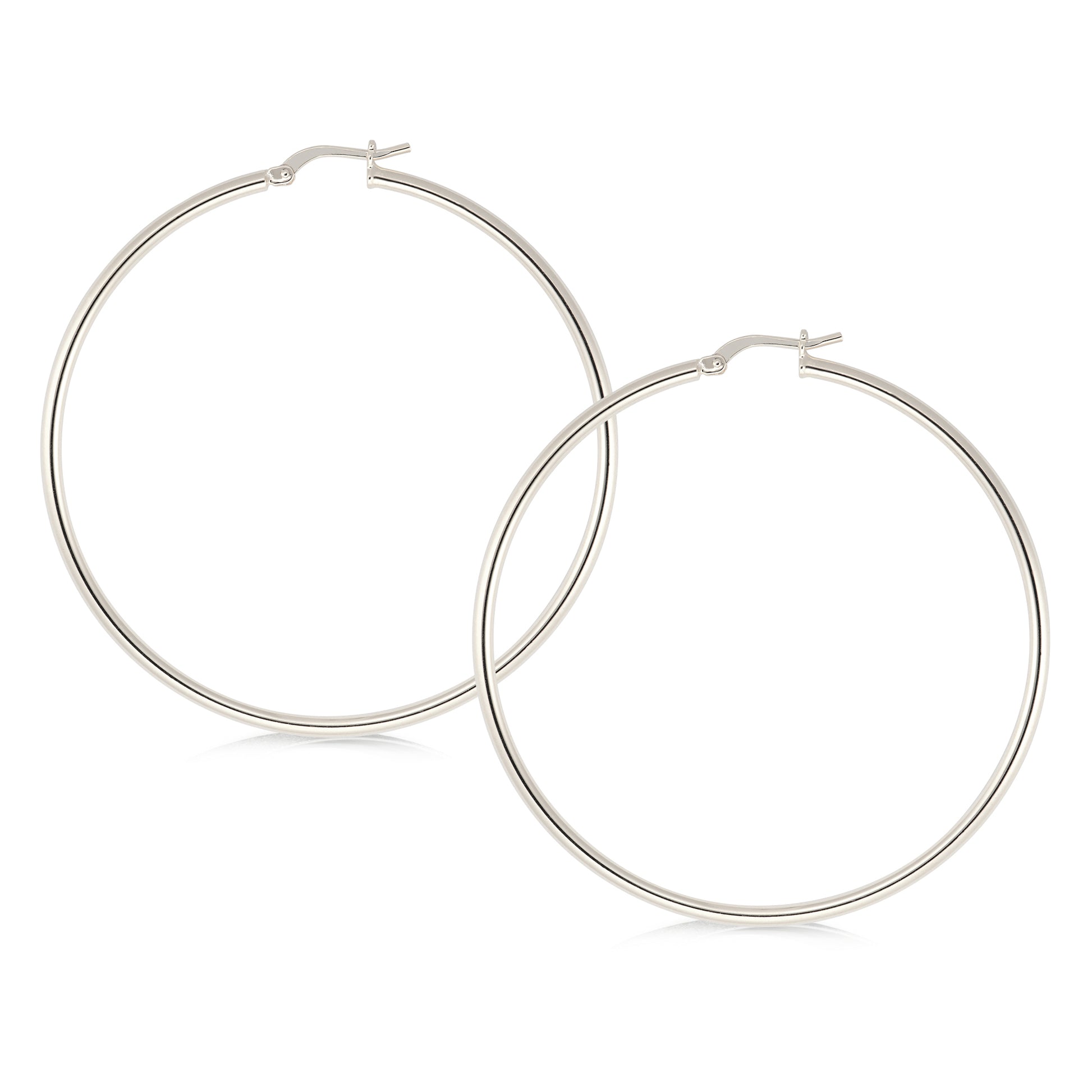 A pair of large, polished silver hoop earrings featuring a sleek and minimalist design. The hoops are circular and feature a smooth, shiny finish that reflects light, enhancing their elegance. The closure mechanism is a simple hinged clasp, ensuring ease of wear while providing a secure fit. These earrings are versatile, suitable for both casual and formal occasions.