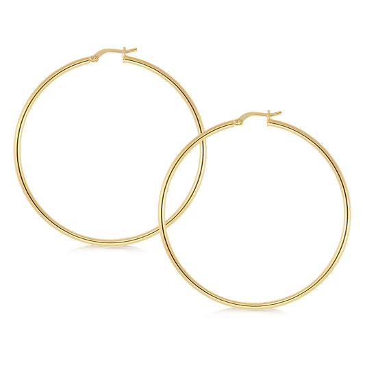 A pair of elegant gold hoop earrings featuring a sleek and minimalist design. The hoops are large and perfectly circular, showcasing a smooth, polished finish that adds a touch of sophistication. The classic hinge closure ensures secure and easy wear, making these versatile earrings suitable for both everyday and special occasions.